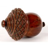 TREEN. A VICTORIAN TURNED AND CARVED COQUILLA NUT NUTMEG GRATER AND COVER OF ACORN SHAPE, 7CM H, MID