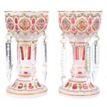 A PAIR OF OVERLAY GLASS LUSTRES, 20TH C, of cranberry glass overlaid in white and painted with