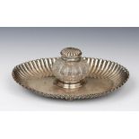 A VICTORIAN REEDED OVAL SILVER INKSTAND with silver mounted cut glass inkwell, 19cm w, by Martin,