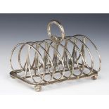 A GEORGE IV SEVEN HOOP SILVER WIREWORK TOAST RACK Smyth crest, 12cm h, by William Eley, London 1825,