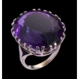 AN AMETHYST RING the oval amethyst 22 x 20mm, in white metal, unmarked, 12.4g, size K++Good