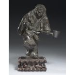 A JAPANESE BRONZE OKIMONO, POSSIBLY OF THE IMMORTAL CHRYSANTHEMUM BOY (KIKUJIDOU), MEIJI PERIOD on