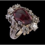 A GARNET AND DIAMOND CLUSTER RING the garnet cabochon approx 13 x 10mm the six round cut diamonds