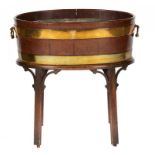 A GEORGE III BRASS BOUND MAHOGANY WINE COOLER AND STAND, C1780 with hinged handles, the stand on