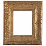 A LOUIS XIV GILTWOOD PICTURE FRAME, 18TH C profusely carved with strapwork, shells to the centres