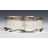 A GEORGE III SILVER WINE COASTER inset turned mahogany base, crested, 12.5cm diam, by Robert,