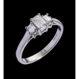 A DIAMOND THREE STONE RING the emerald cut diamonds weighing approx 0.55ct in total, in platinum,