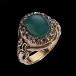 A GREEN STONE AND DIAMOND CLUSTER RING closed back setting, in gold, unmarked, 13.4g, size M++Good