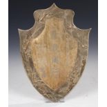 A CHINESE SHIELD SHAPED REPOUSSÉ PLAQUE, LATE 19TH C the reverse with four fixing bolts and silver