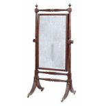 A GEORGE IV MAHOGANY CHEVAL MIRROR, C1825, reeded throughout, with urn finials, on brass castors,