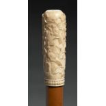 AN IVORY HANDLED MALACCA WALKING CANE, 19TH C the handle carved in shallow relief with birds in