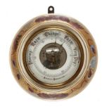 A VICTORIAN GILT GROUND EARTHENWARE ANEROID BAROMETER, C1880 the red and black printed register with