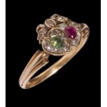 A RUBY, EMERALD AND DIAMOND LINKED HEARTS RING in gold, unmarked, 3.2g, size N++Good condition