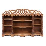 A VICTORIAN SERPENTINE WALNUT OPEN BOOKCASE, C1870 with fretwork back and tapering spiral pillars,