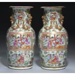 A PAIR OF CANTON FAMILLE ROSE VASES, QING DYNASTY, 19TH C enamelled to either side with a larger