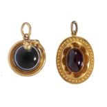 TWO VICTORIAN AGATE OR FOILED GARNET CABOCHON MOURNING PENDANTS, C 1870 in gold, the reverse inset