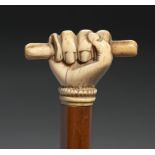 SCRIMSHAW. A MALACCA WALKING CANE WITH MARINE IVORY CLENCHED FIST POMMEL, 19TH C brass tip, 89cm++