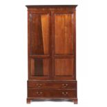 A HIGHLY FIGURED MAHOGANY WARDROBE, EARLY 20TH C with dentil cornice, the doors with raised and