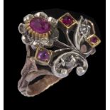 A RUBY AND DIAMOND FLOWER RING in gold and white gold with chased shoulders, unmarked, 5g, size M++