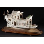 A CANTON IVORY MODEL OF A PLEASURE BOAT, MID 19TH C 27cm h, on contemporary Victorian bow ended