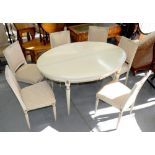 AN EXTENDING DINING TABLE AND SET OF SIX DINING CHAIRS, IN A FRENCH EMPIRE STYLE, PAINTED IN LIGHT