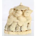 A JAPANESE IVORY OKIMONO OF A GROUP OF FIGURES BENEATH A PARASOL, 5CM H, MEIJI PERIOD