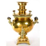 A RUSSIAN BRASS SAMOVAR WITH TURNED EBONISED HANDLES, SHOULDER STAMPED WITH MEDALS AND CYRILLIC