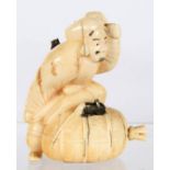 A JAPANESE IVORY OKIMONO OF A MAN BRANDISHING A MALLET OVER A RAT, 7.5CM H, MEIJI PERIOD ++Uneven