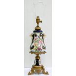 A GILTMETAL MOUNTED CONTINENTAL PORCELAIN OIL LAMP, PAINTED WITH FLOWERS IN COBALT AND GILT BORDERS,