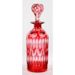 A CRANBERRY FLASHED AND FLUTE CUT DECANTER AND STOPPER