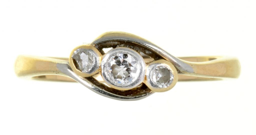 A THREE STONE DIAMOND RING IN GOLD, MARKED 18CT 2.8G, SIZE M ++BUILD UP OF DIRT AND GRIME AROUND