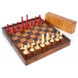 A VICTORIAN INLAID MAHOGANY FOLDING GAMES BOARD, 28CM L AND A VICTORIAN TURNED BONE CHESS SET,