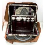 A LATE VICTORIAN LEATHER DRESSING CASE, THE CENTRE SECTION RETAINING THE SIX GLASS JARS, EACH WITH