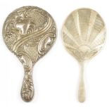 TWO SILVER HAND MIRRORS, ONE EMBOSSED WITH ROCAILLE AND TRELLIS, THE OTHER ENGRAVED WITH BUTTERFLY