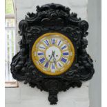 A PROFUSELY AND EBONISED NAPOLEON III WALL CLOCK, THE GILT BRASS DIAL WITH BLUE ENAMEL CHAPTERS,