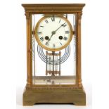 A FRENCH GILT BRASS FOUR GLASS MANTEL CLOCK, WITH ENAMEL DIAL AND MERCURY COMPENSATED PENDULUM, IN