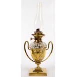 AN EDWARDIAN TWO HANDLED BRASS OIL LAMP, THE DETACHABLE CUT GLASS FOUNT WITH MESSENGER'S PATENT