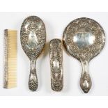 AN EDWARD VII THREE PIECE SILVER BRUSH SET, BIRMINGHAM 1909 AND A SILVER MOUNTED COMB