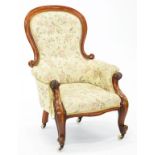 A VICTORIAN MAHOGANY ARMCHAIR ON CARVED SCROLLING LEGS