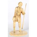 A JAPANESE CARVED IVORY OKIMONO OF A FISHERMAN, 15.5CM H, MEIJI PERIOD ++Losses and cracks, much