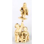 A JAPANESE IVORY OKIMONO OF THREE FIGURES, 12CM H, MEIJI PERIOD ++Wrist of larger figures upraised