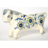 ARNOLD MACHIN. A WEDGWOOD QUEENSWARE MODEL OF FERDINAND THE BULL, C1941, PAINTED IN BLUE AND YELLOW,