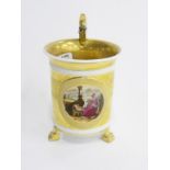A CONTINENTAL EMPIRE STYLE GILT GROUND PARTLY BISCUIT CABINET CUP, PAINTED WITH A WOMAN AND CHILD,
