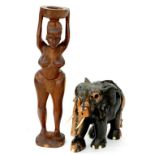 A CARVED AND EBONISED HARDWOOD ELEPHANT AND A CARVED HARDWOOD FIGURE OF A LADY, 85CM H