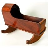 A VICTORIAN MAHOGANY DOLL'S CRADLE WITH REPLACEMENT DEAL END AND BEECH ROCKERS, 42CM L