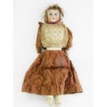 A BISQUE HEADED CHARACTER DOLL, WITH OPEN MOUTH WITH FOUR UPPER TEETH, PAINTED EYEBROWS AND