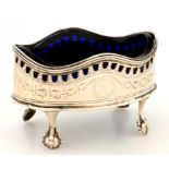 A GEORGE III PIERCED AND ENGRAVED OVAL SILVER SALT CELLAR WITH UNDULATING RIM ON CLAW AND BALL FEET,