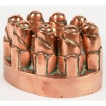 AN OVAL COPPER JELLY MOULD OF TURRET FORM BY BENHAM & FROUD, 17CM L, STAMPED MARK, C1900