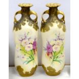 A PAIR OF AMPHORA TWO HANDLED, WAISTED VASES, DECORATED WITH NATURALISTIC FLOWERS ON A PALE YELLOW