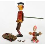 A PAINTED WOOD AND TINPLATE SCOTSMAN PUPPET, 32CM H, A CLOCKWORK CLOWN TOY WITH CELLULOID HEAD AND